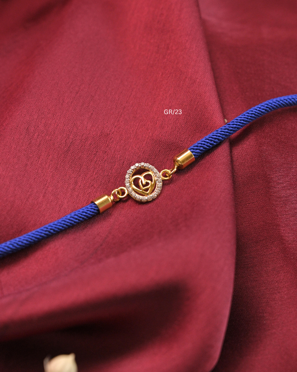 Interlocking Dual Hearts & CZ Circular Halo Rakhi with Royal Blue Thread |SKU: GR/23