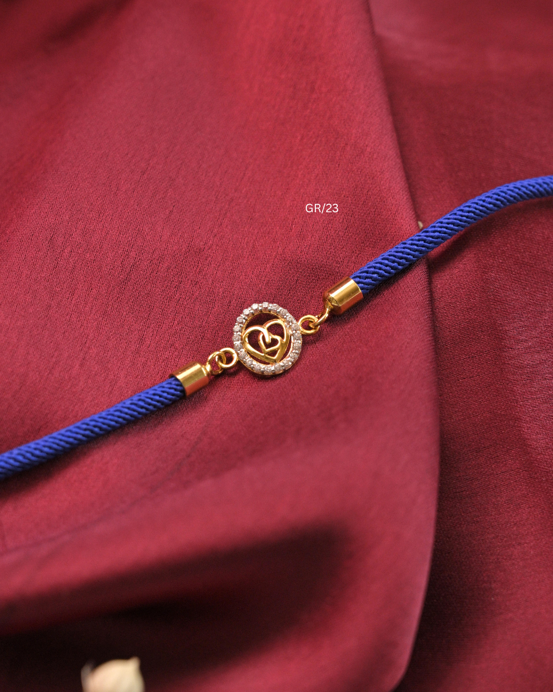 Interlocking Dual Hearts & CZ Circular Halo Rakhi with Royal Blue Thread |SKU: GR/23