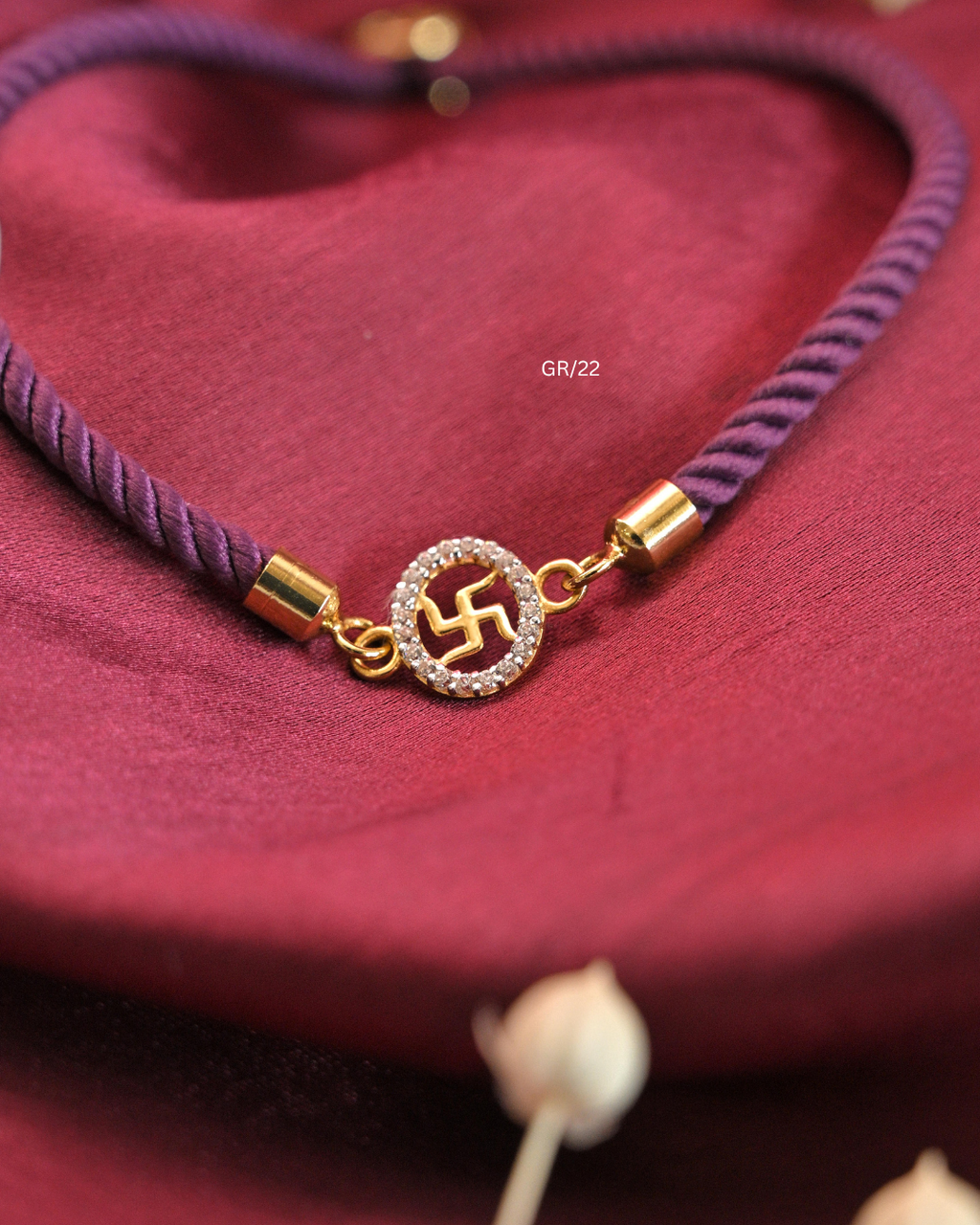 Sacred Swastik & CZ Oval Halo Rakhi with Purple Thread | SKU: GR/22