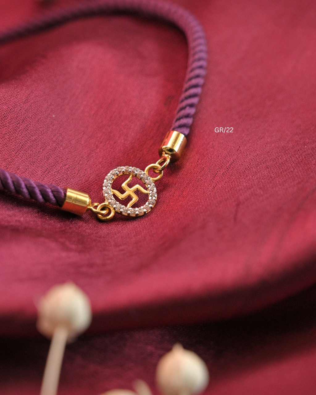 Sacred Swastik & CZ Oval Halo Rakhi with Purple Thread | SKU: GR/22