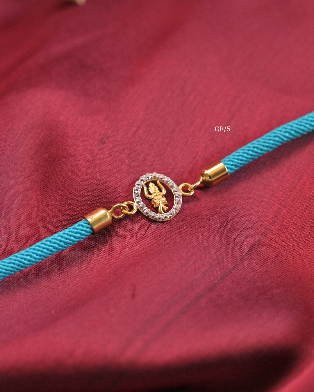 Sacred Trishul Damru & CZ Halo Rakhi with Cyan Thread |SKU: GR/5