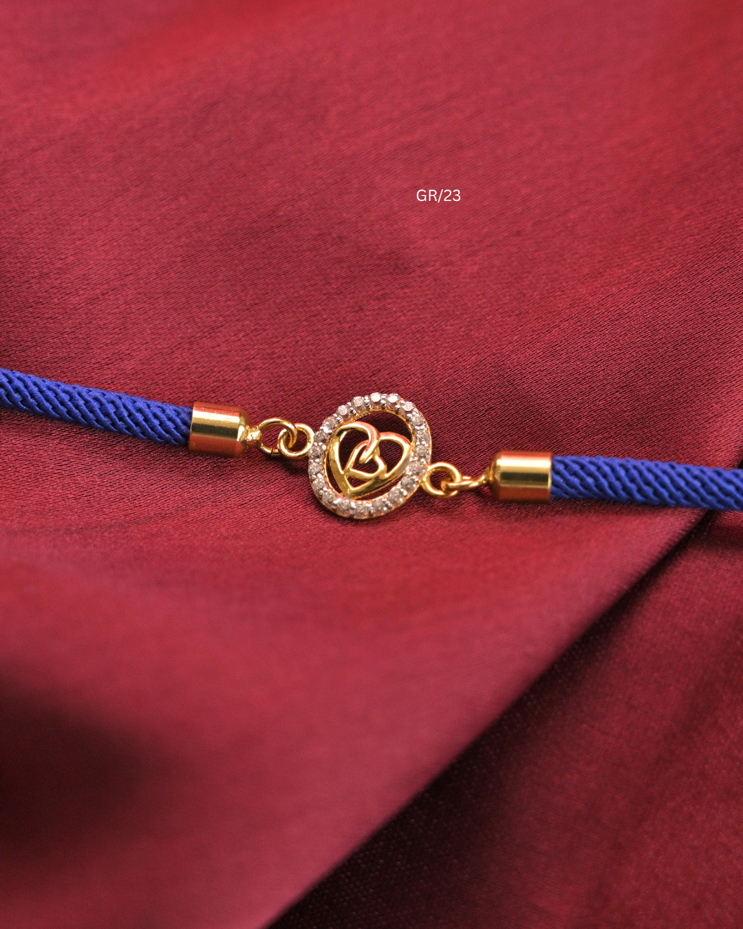 Interlocking Dual Hearts & CZ Circular Halo Rakhi with Royal Blue Thread |SKU: GR/23
