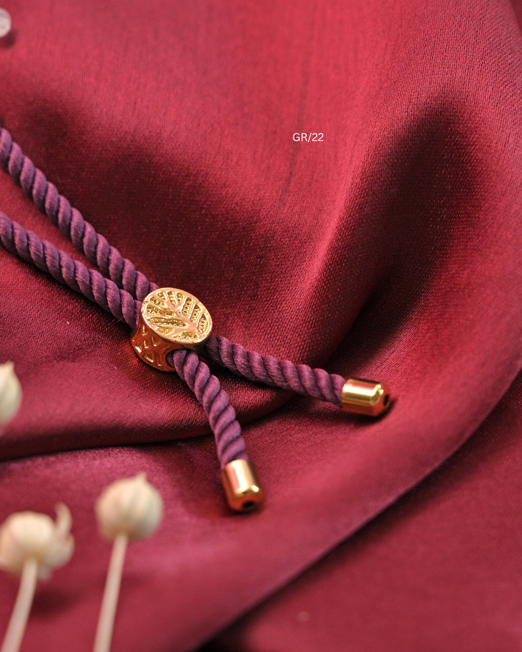 Sacred Swastik & CZ Oval Halo Rakhi with Purple Thread | SKU: GR/22