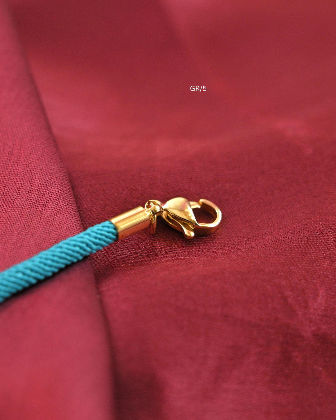 Sacred Trishul Damru & CZ Halo Rakhi with Cyan Thread |SKU: GR/5